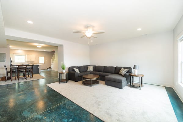 Bright common area with a sectional sofa and table