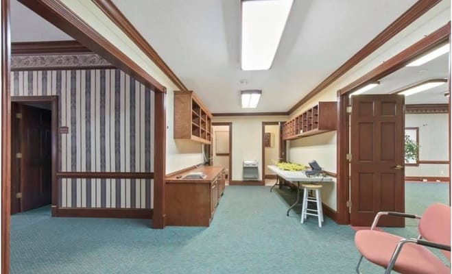Interior view of a facility hallway with desks