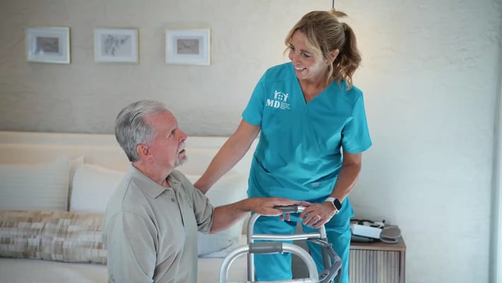 Care staff assisting a resident in a bright room