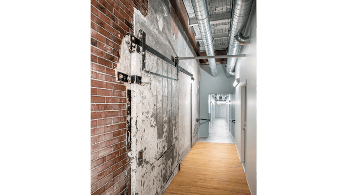 Charming hallway with exposed brick and wooden flooring