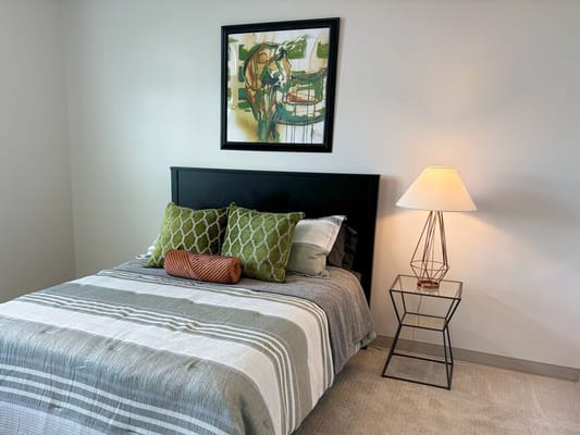Cozy bedroom with decorative pillows and lamp