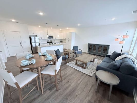 Bright and inviting living room with seating and dining area