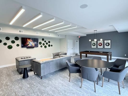 Modern common area with seating and game table