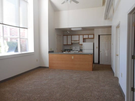 Interior view of a vacant apartment unit with kitchen