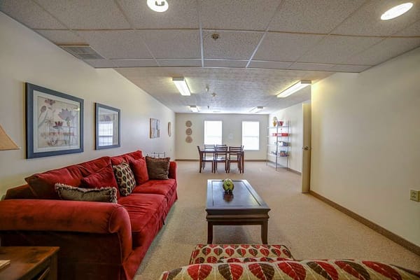 Common area in a senior living facility with couches and dining table