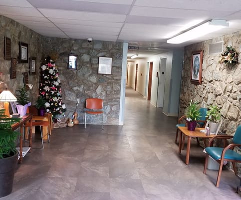 Interior view of the lobby with a Christmas tree and seating areas.