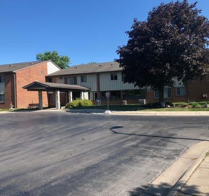 Main entrance of Friendship Haven senior living facility with a canopy and landscaped area.