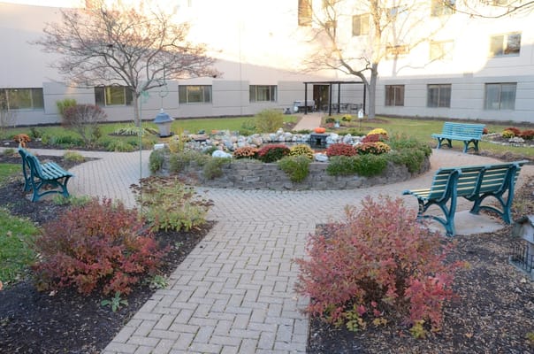 Well-maintained outdoor garden area with benches and flowers