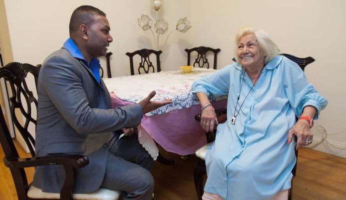 A staff member talking with a resident in a cozy room