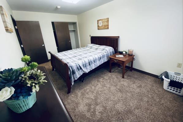 A cozy bedroom setup in assisted living apartment
