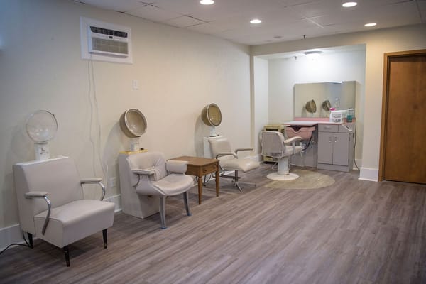 Interior view of a salon area with chairs and mirrors
