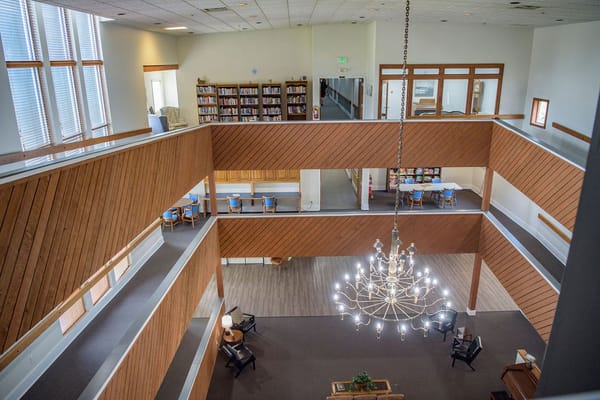 Interior view of a spacious common area with a chandelier