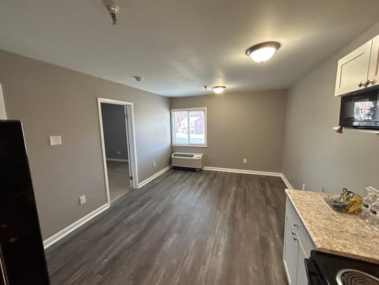 Interior view of a vacant room with a kitchenette