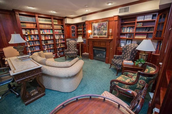 Cozy library area with bookshelves and comfortable seating