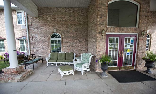 Outdoor seating area with furniture and flowers
