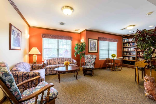 Comfortable common area with seating and bookshelf