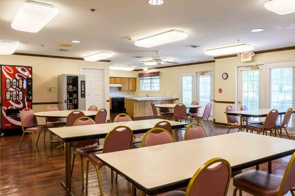 Brightly lit dining room with tables and chairs