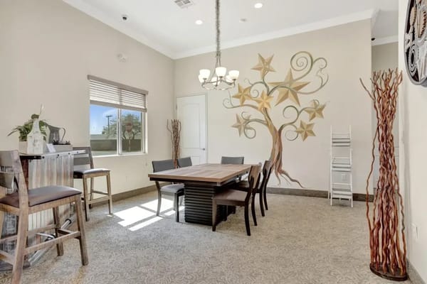 Interior common area with a dining table and decorative wall art