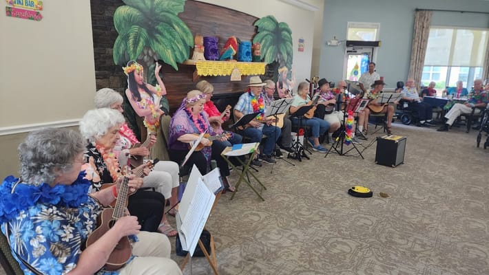 Residents enjoying a musical performance in the activity center