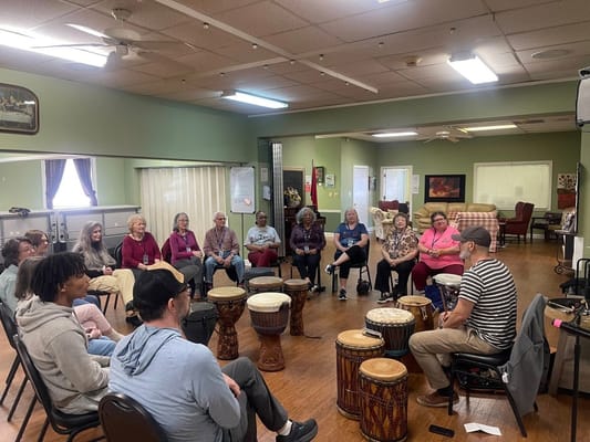 Residents participating in a drum circle activity