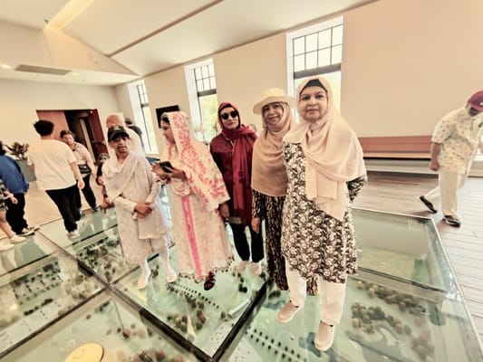 Group of women engaging with a model display at Capital Care