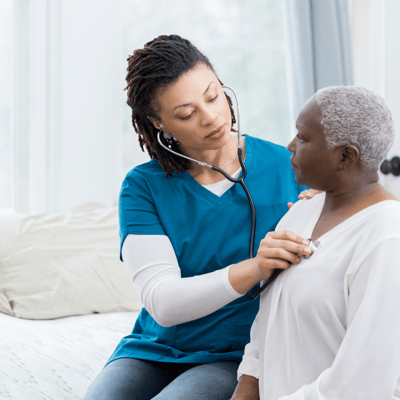 Health care worker examining a senior resident