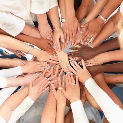 A diverse group of hands joining together in unity