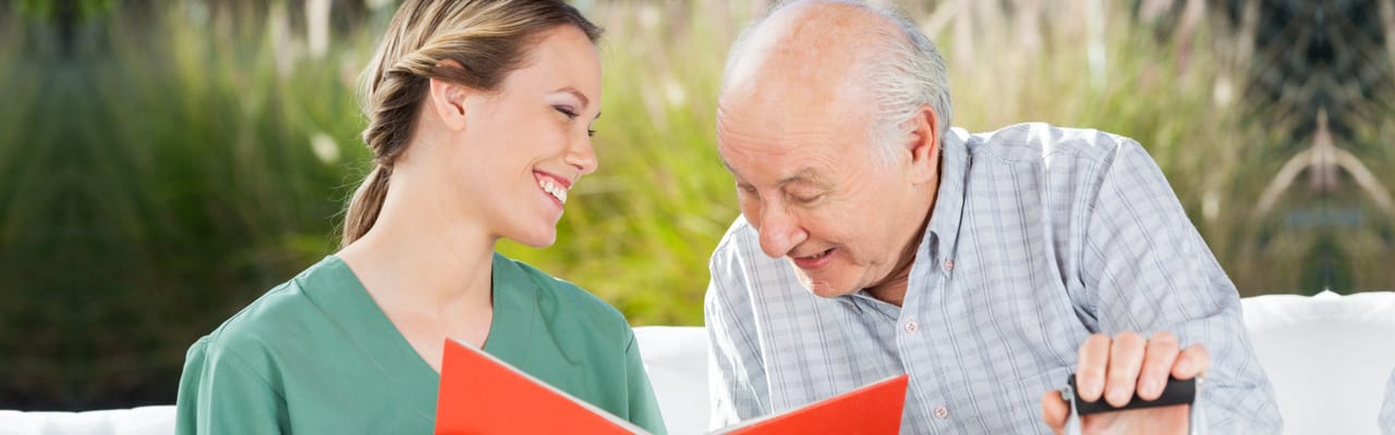 Caregiver interacting with a senior resident outdoors