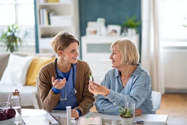 Healthcare worker interacting with a senior resident