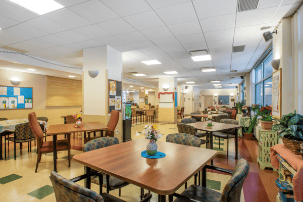 Common area of a senior living facility with tables and chairs