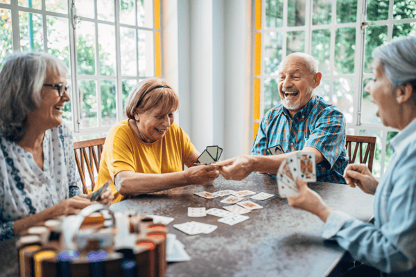 Residents enjoying a card game in a common area