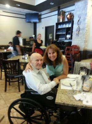 Resident and staff member in a dining room setting