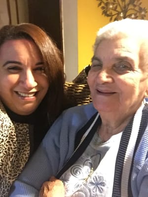 Resident and staff member smiling together