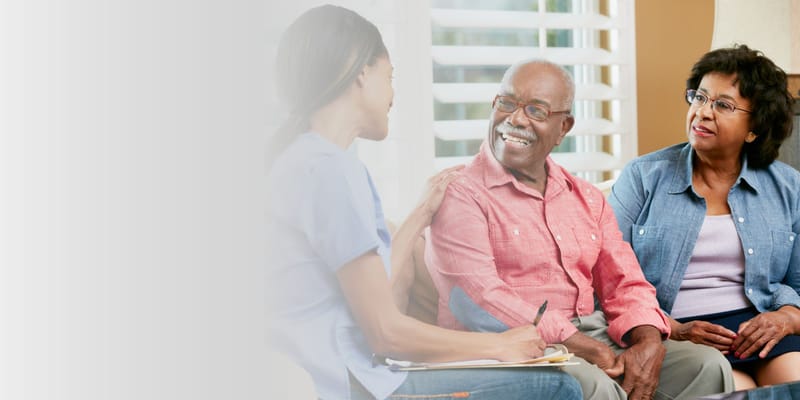 A staff member engaging with two residents in a common area