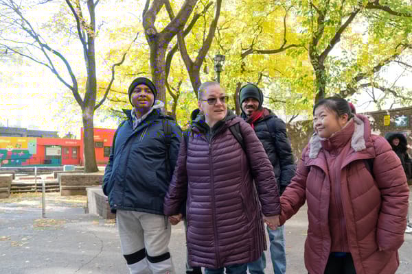 Residents enjoying a walk in a sunny outdoor space