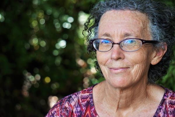 Smiling senior woman with glasses outdoors