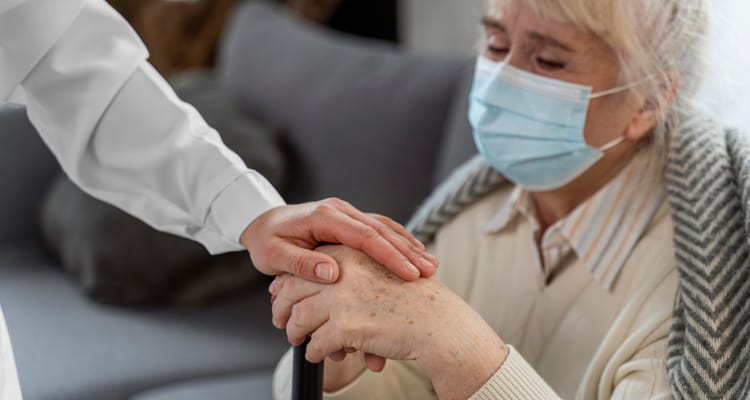 Caregiver comforting a senior resident indoors