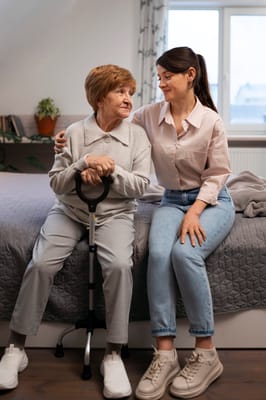 Caregiver interacting with an elderly resident in a room