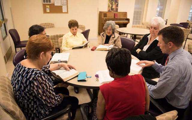 Residents participating in a Bible study group.