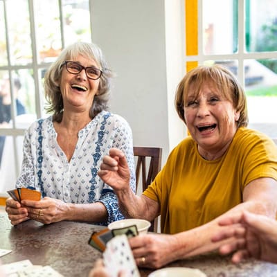 Two women enjoying a card game indoors