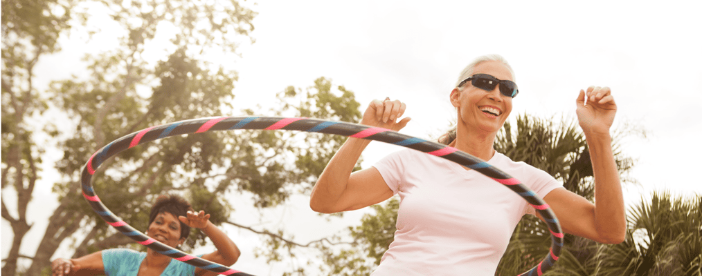 Residents enjoying outdoor hula hoop activity