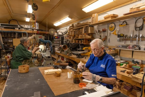 Residents engaged in woodworking in a workshop