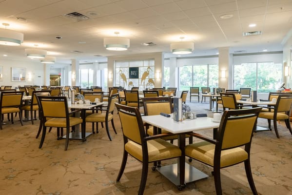Bright dining room with tables set for meals