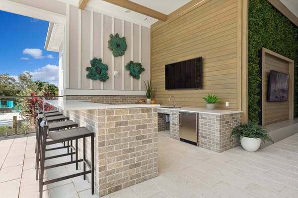 Outdoor entertaining area with seating and a television