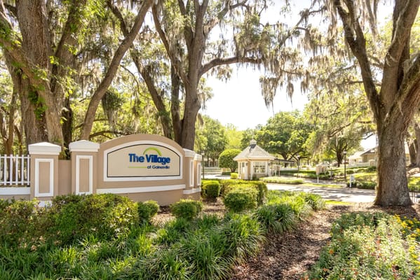 Entrance of The Village at Gainesville with greenery
