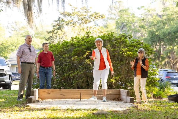 Residents enjoying an outdoor game activity in the garden.