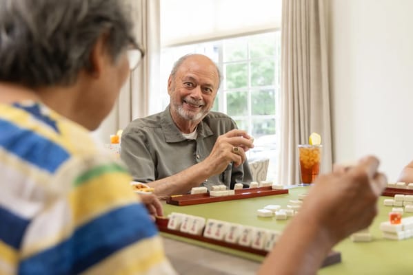 Residents enjoying a game of mahjong in a common area