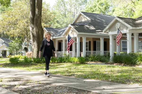 Resident walking along a path with cottages in view