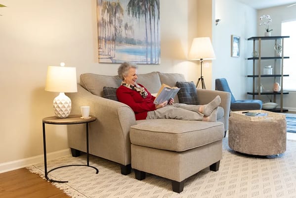 Resident reading in a cozy living room setting