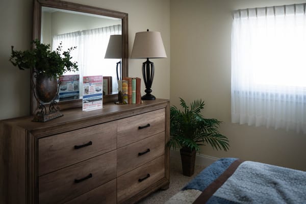 Cozy resident room with dresser and lamp